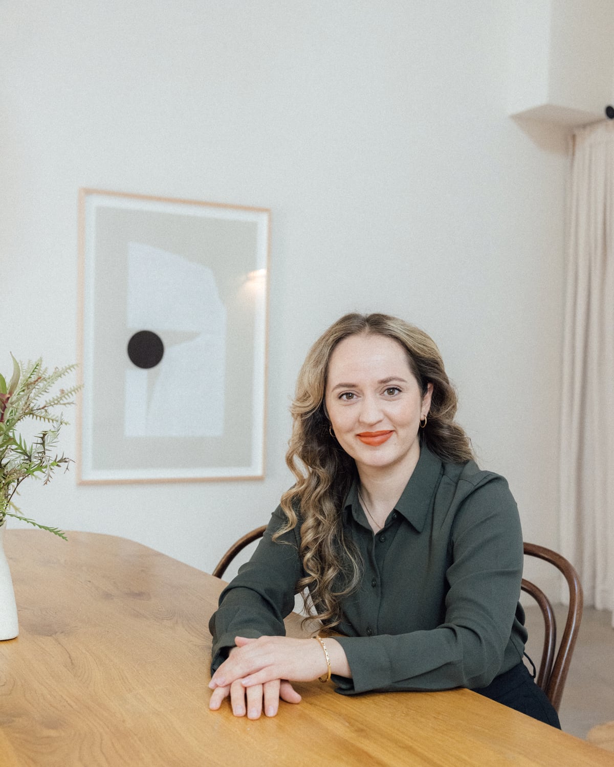Valerie Stevens, founder of A Little Often and a community mediator, seated at her table.